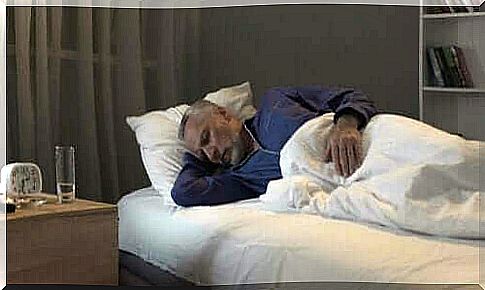Older man sleeping in bed