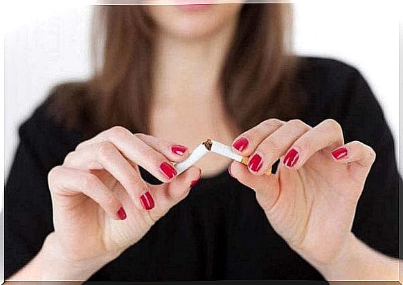 Woman breaks cigarette in half