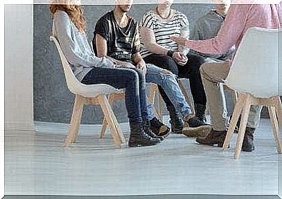 People sit in a circle at group therapy