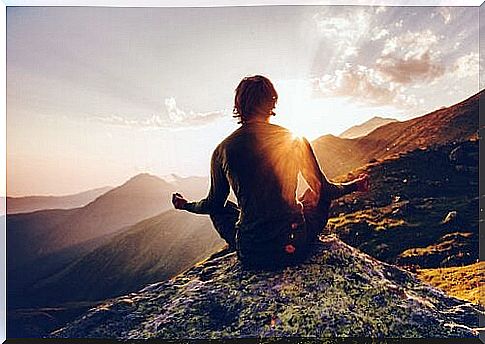 A man meditating on a mountain