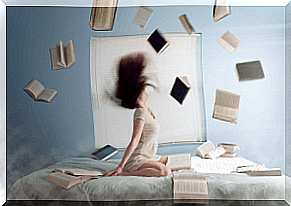 A woman sits up in bed with books flying around her
