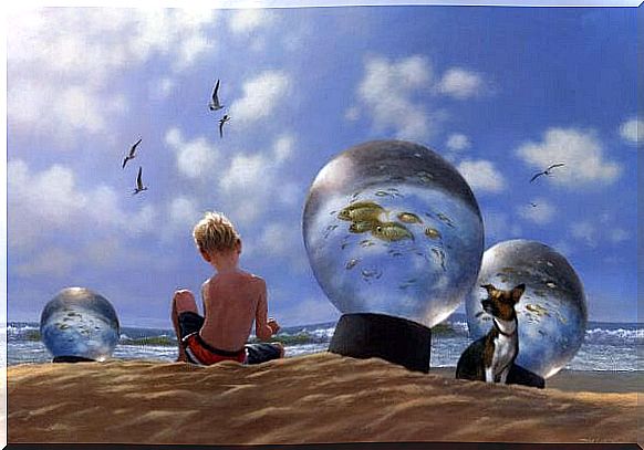Little boy is playing on the beach between the glass balls