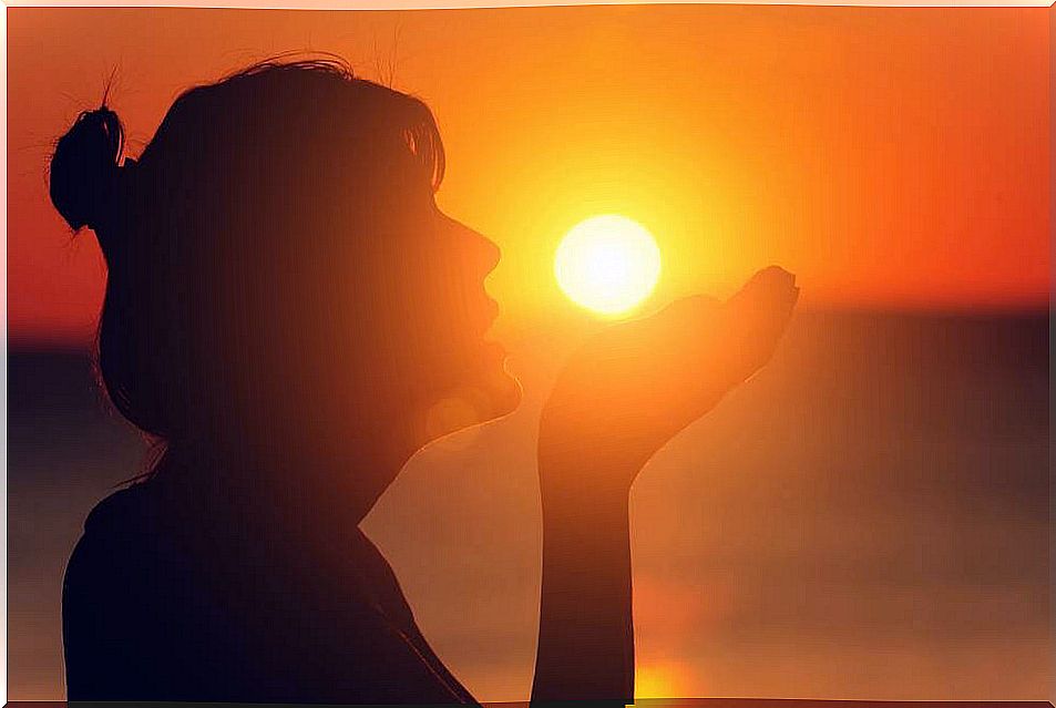 Woman Holding The Setting Sun On Her Hand To Soothe Pain After Loss